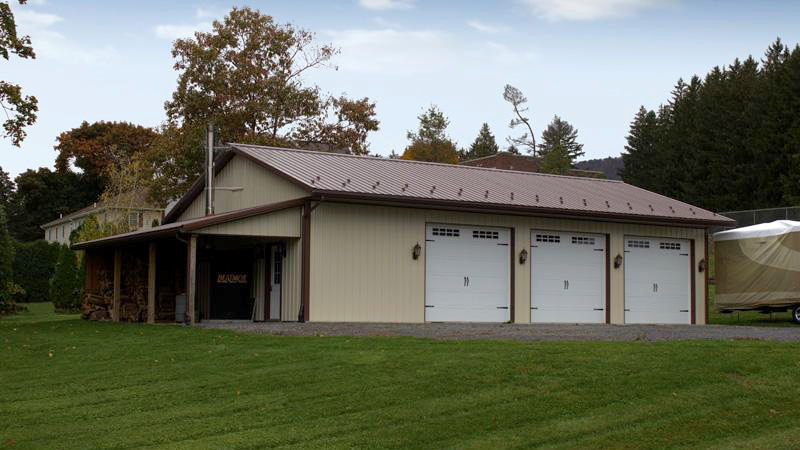 three overhead door brown and beige building with porch