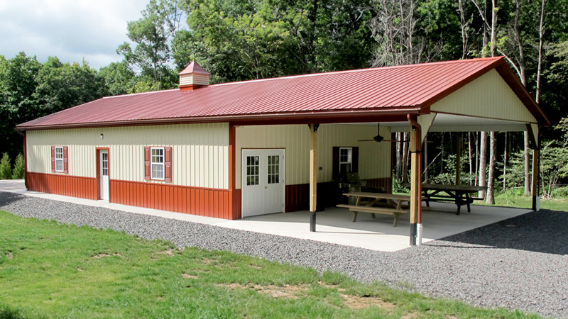 red and page pole building with porch