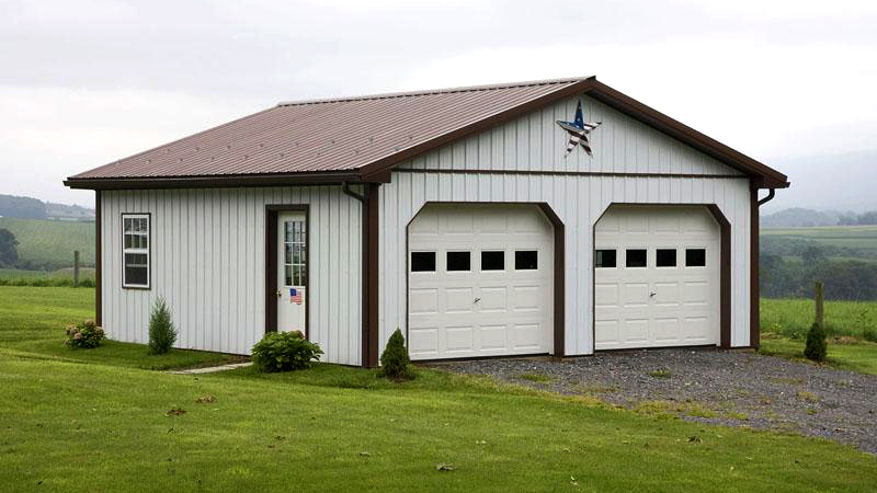 white and brown building with two garage doors