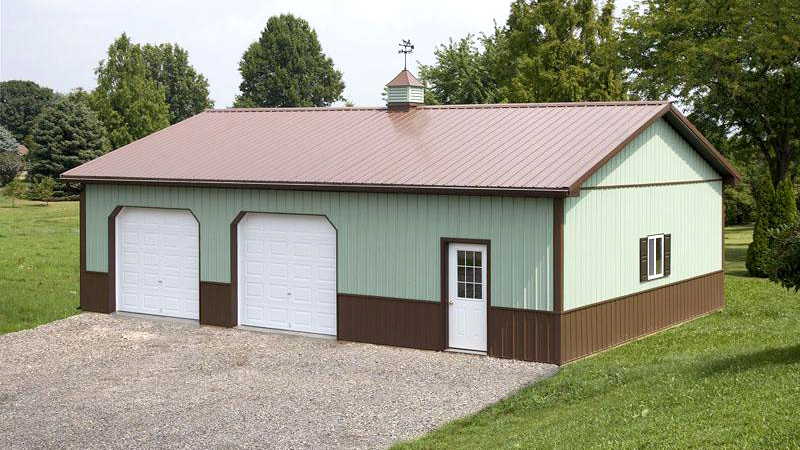 two garage door building in light green with brown