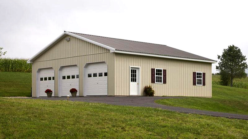 three garage door beige building with white trim