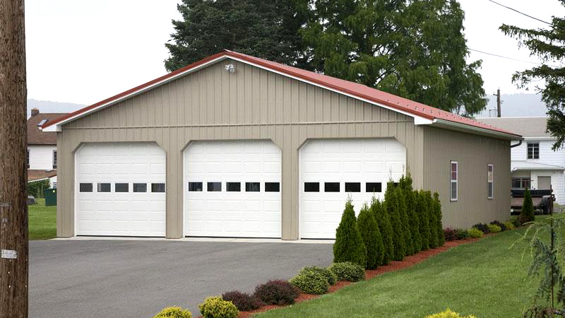 three overhead door garage brown building