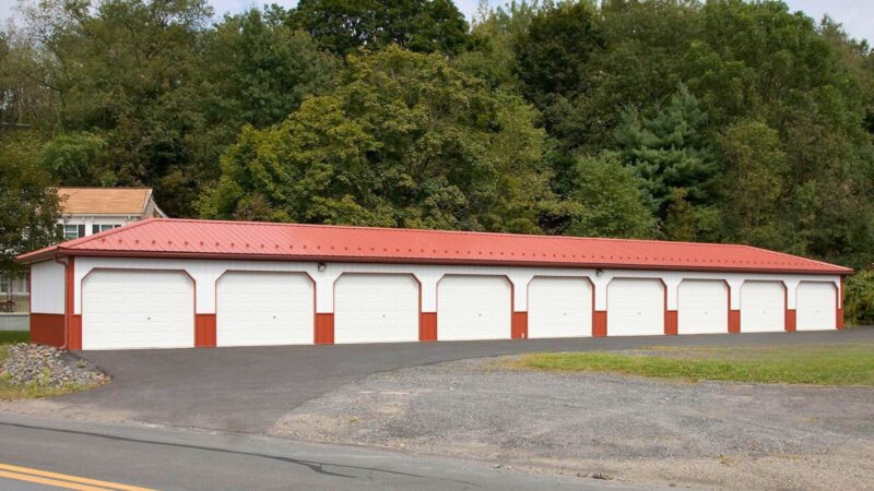 108x20 multi unit storage building with 9 raised panel garage doors and scarlet red roof