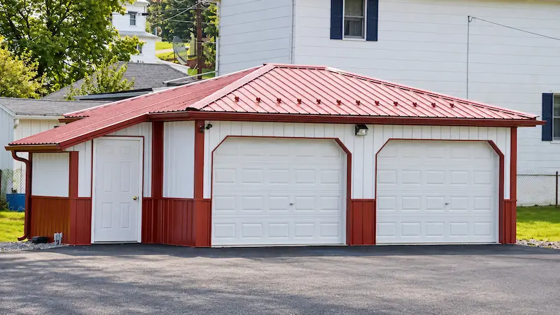 Two-unit mini storage building with separate overhead doors, an attached utility room, and a Scarlet Red hip roof