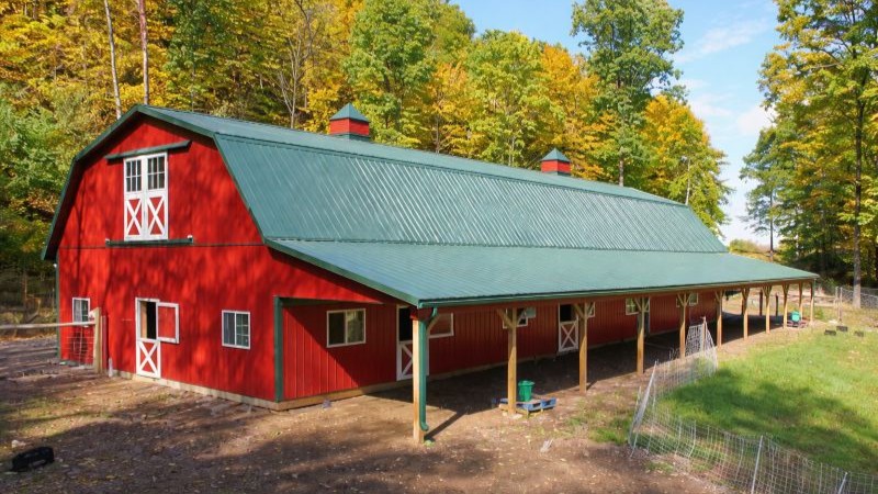 204-40×100 Equine Barn with Stalls and Dutch Doors Equine pole building in Pennsylvania with horse stalls, red steel siding and evergreen roof