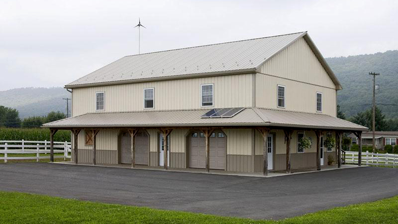 beige and gray two story pole building with solar panels