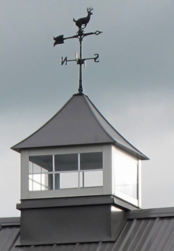 cupola with deer weathervane and windows