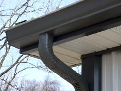 close up of rain gutter with connected downspout