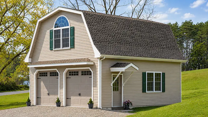 24x28 residential pole building with gambrel roof vinyl siding white trim and carriage garage doors