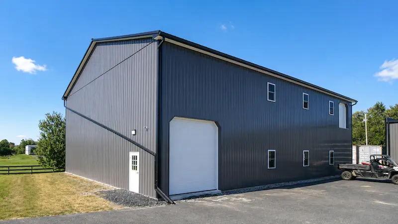 50x80 two-story commercial pole building with charcoal metal siding and black trim
