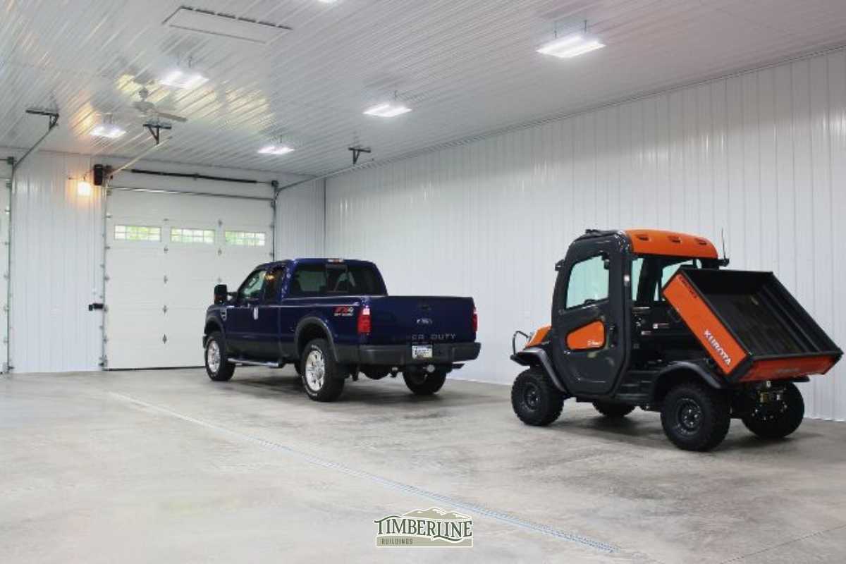 Interior of a Timberline pole barn garage with vehicles parked indoors, showing space for hobbies, family projects, and protection from the elements