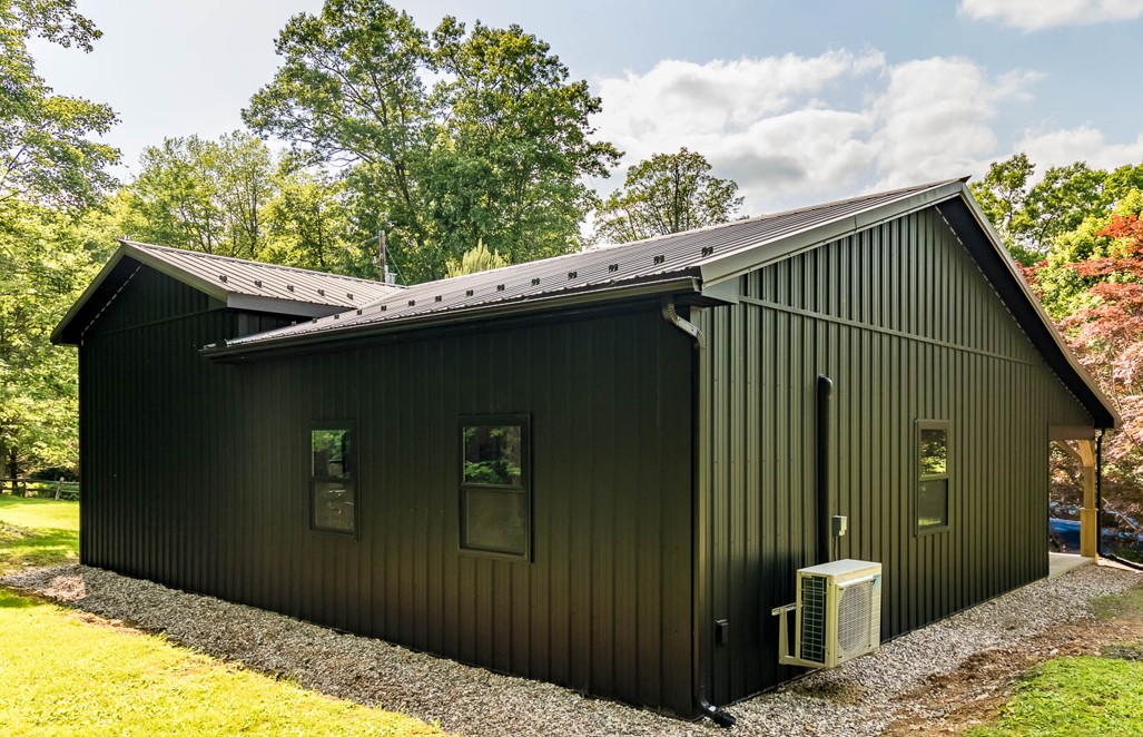 Black Residential Pole Building with Gutter Black metal residential pole building with matching black gutter and downspout