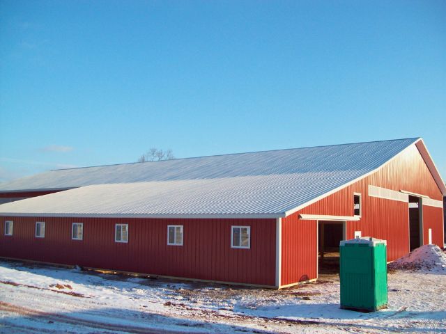 Completed red post-frame building by Timberline Buildings standing on snow-covered ground in rural Pennsylvania.