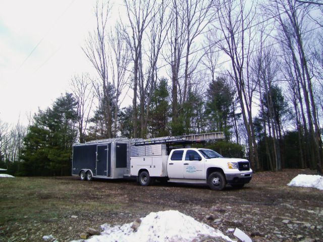 Timberline Buildings service truck and equipment at a snowy job site prepared for winter construction.