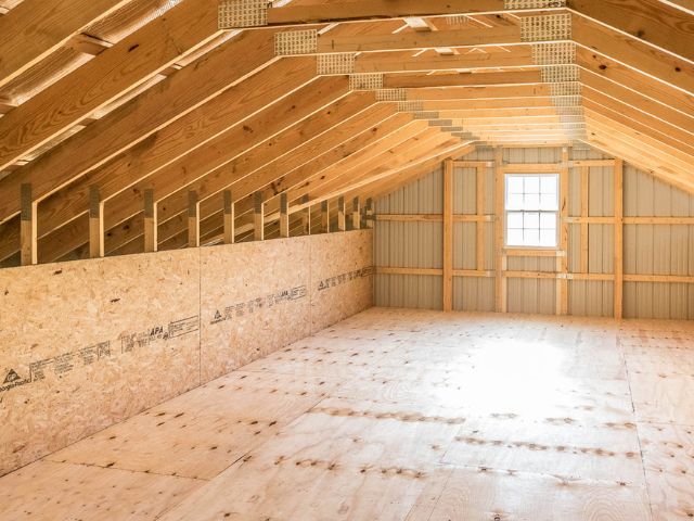 Finished pole barn attic with bright natural light and wood framing