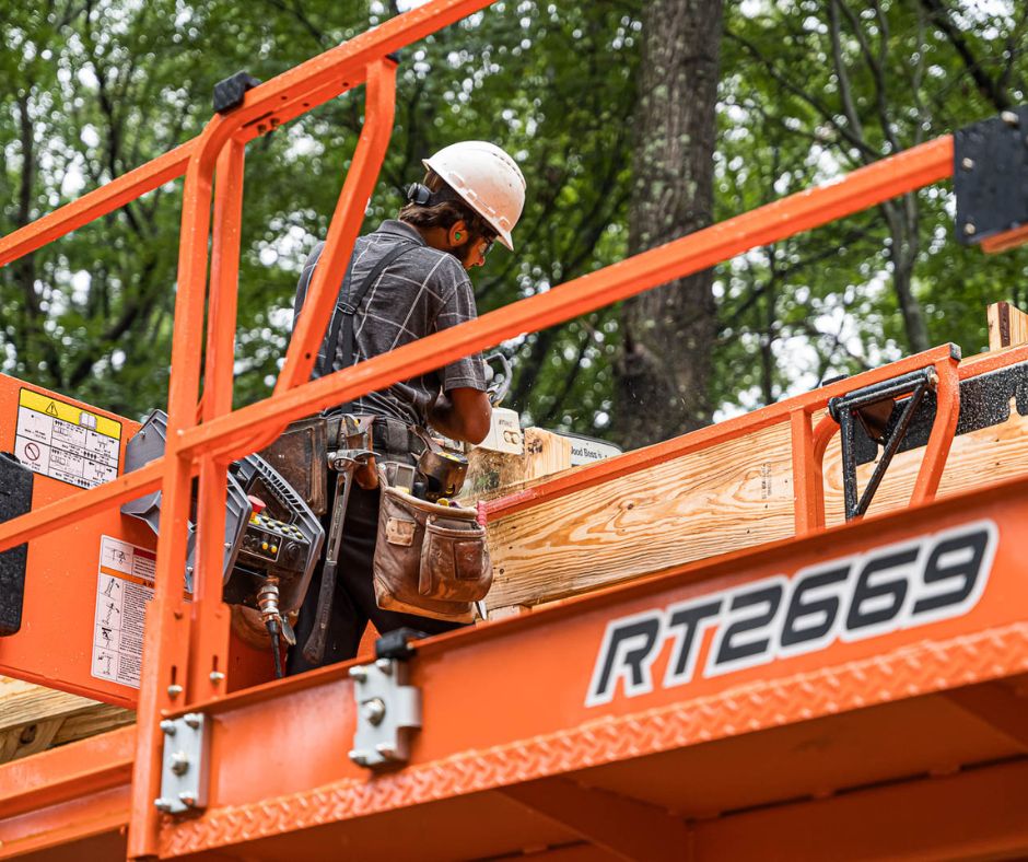 Experienced construction worker on a lift platform preparing materials at a Timberline Buildings job site in Pennsylvania