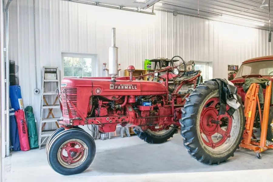 Organized farm equipment inside a post-frame pole barn designed for efficient workflow