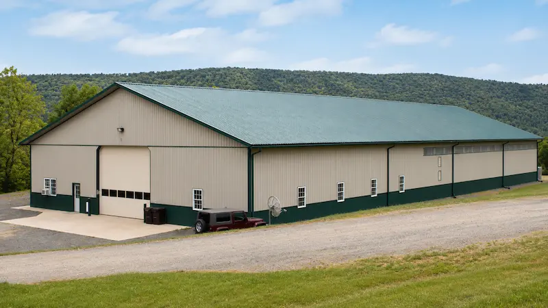 Agricultural spray equipment storage building with spill containment and skylights