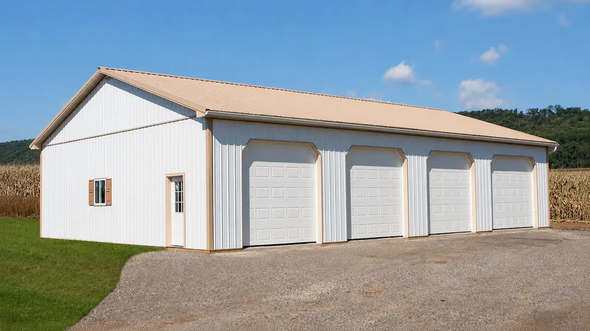 40x60 Bright White Agricultural Barn with 4 Garage Doors and Tan Trim