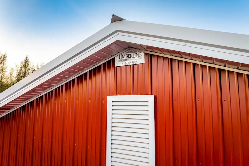 Close-up view of metal siding and trim details on a modern post-frame pole building in Pennsylvania