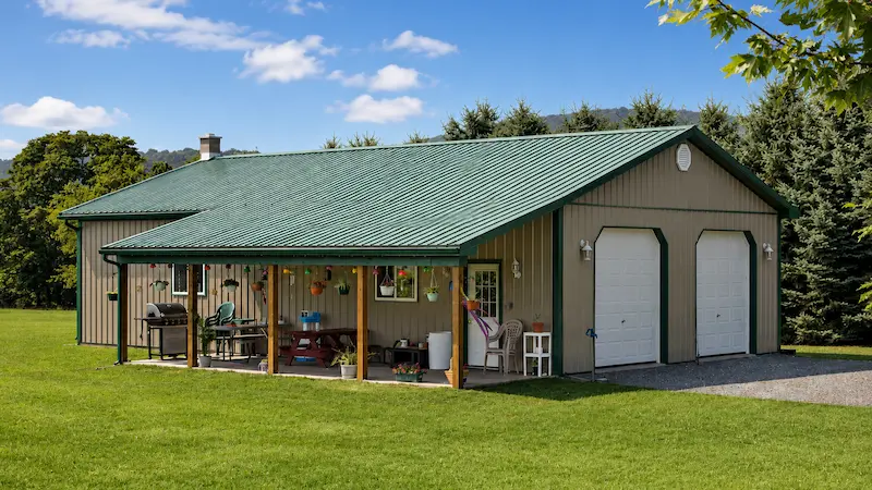 30x50 clay pole barn with evergreen roof and trim, 8x32 lean-to, garage doors, entry door, and windows