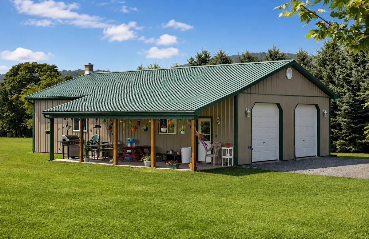 30x50 clay pole barn with evergreen roof and trim, 8x32 lean-to, garage doors, entry door, and windows