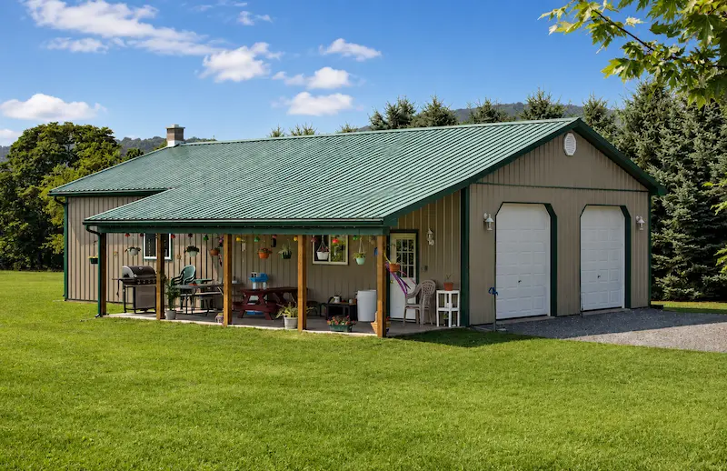 30x50 clay pole barn with evergreen roof and trim, 8x32 lean-to, garage doors, entry door, and windows