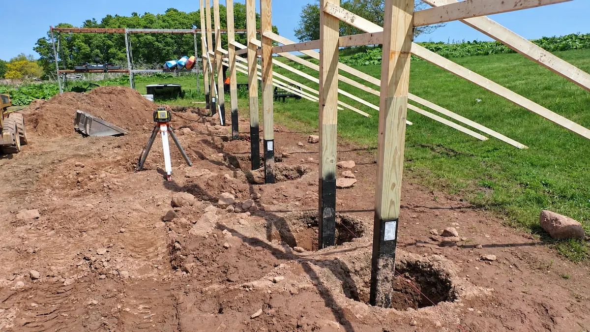 Embedded posts installed in individual pole barn foundation holes