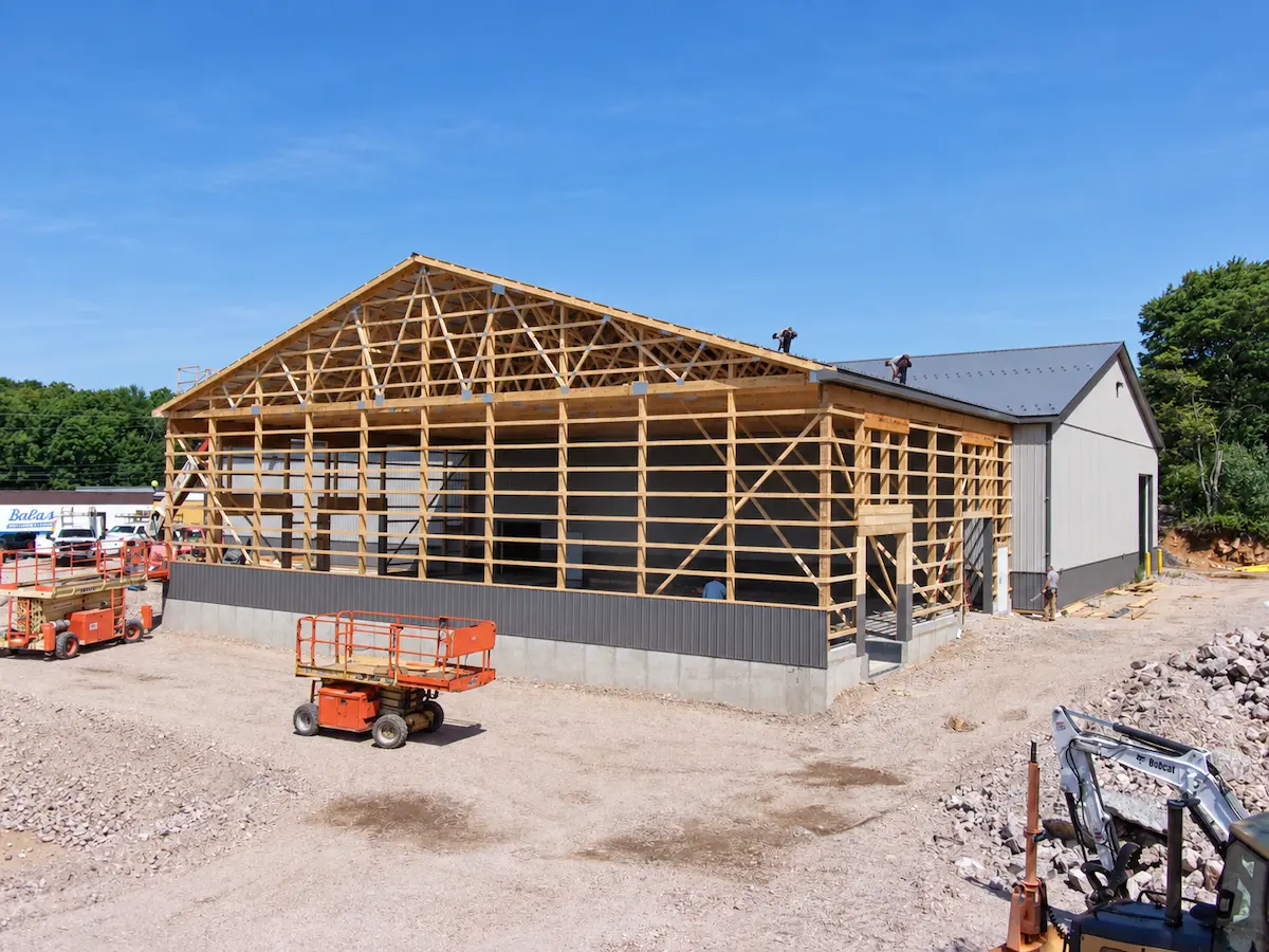 Post-frame building supported by a continuous concrete foundation